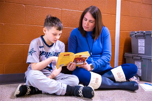 Volunteers reading with students. 